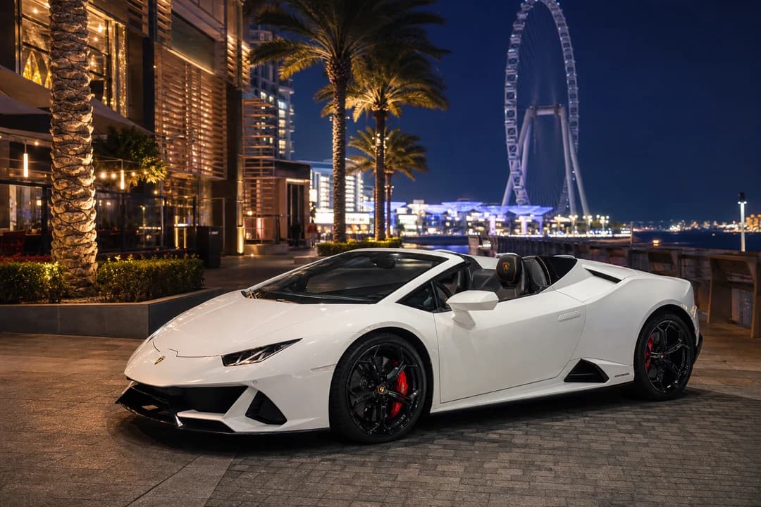 Lamborghini Huracán Spyder roof-down at JBR after sunset for waterfront open-top theatre