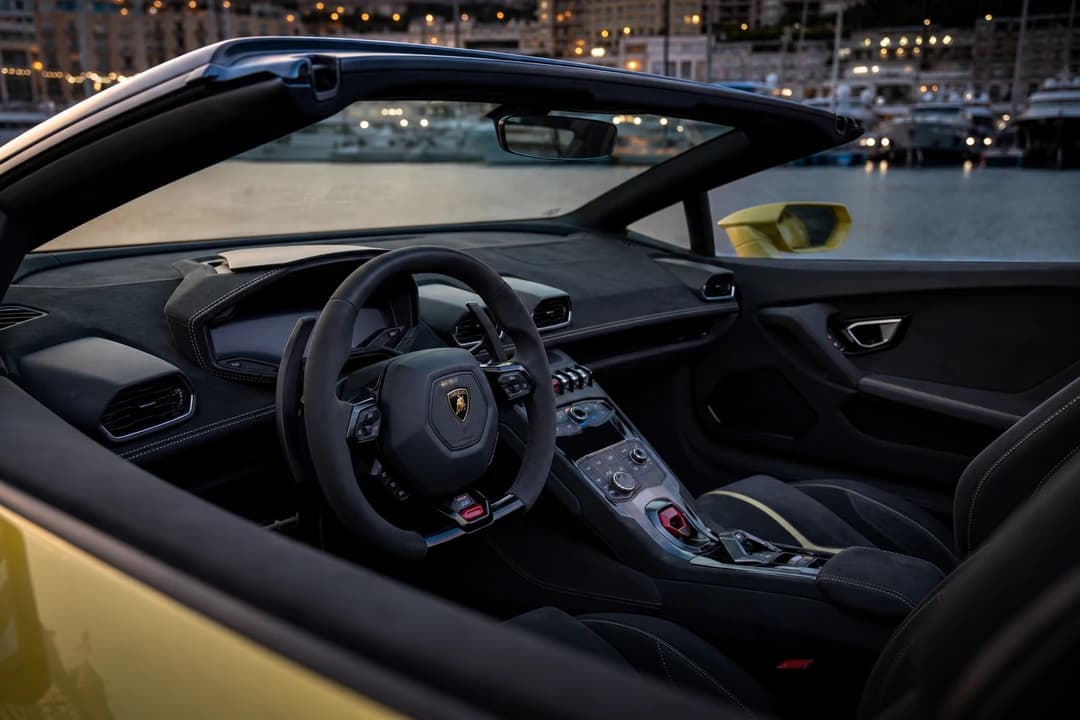 Lamborghini Huracan Spyder hire Dubai cockpit with roof down for luxury car rental Dubai open-air evenings