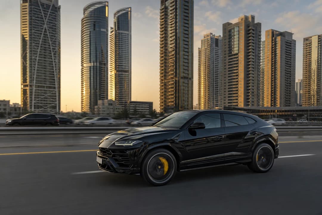 Lamborghini Urus on Sheikh Zayed Road with Marina towers for luxury SUV rental Dubai commutes