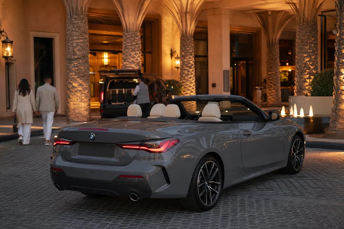 Best cars to rent Dubai in winter: BMW 430i Convertible at a Palm Jumeirah hotel valet in cool evening light
