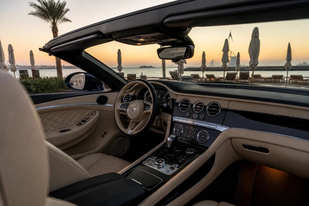 Bentley Continental GTC open cabin overlooking La Mer beach umbrellas for beach day car Dubai plans