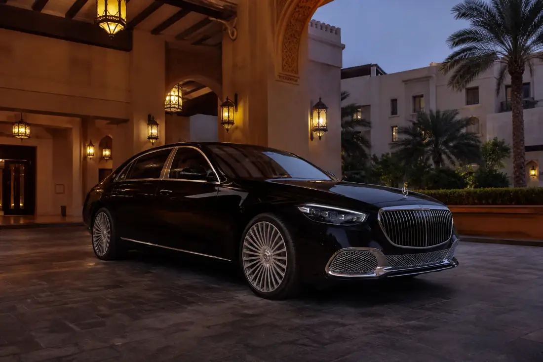 Mercedes Benz luxury car rental Dubai hero with a Maybach S 580 at a Downtown hotel at dusk