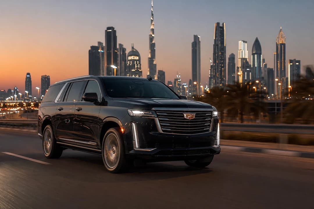 Cadillac Escalade on Sheikh Zayed Road at dusk for supercar rental Dubai guests who actually need full-size SUV miles
