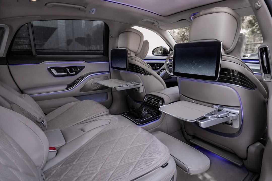 Mercedes-Maybach S-Class rear lounge with screens and tables for Mercedes Maybach S Class hire Dubai comfort