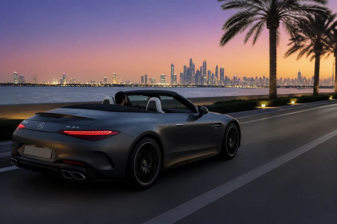Mercedes SL43 on Palm Jumeirah coastal road at blue hour for exotic car rental Dubai open-top evenings