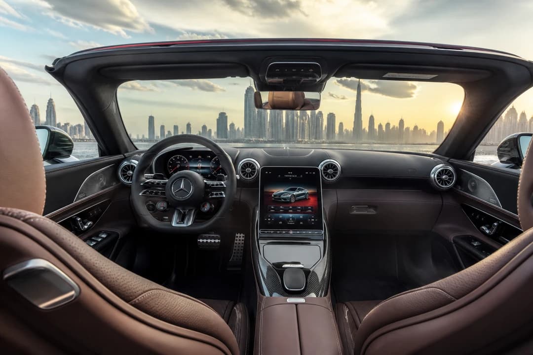 Mercedes SL43 hire Dubai cockpit with AMG wheel and digital displays for coastal dusk drives
