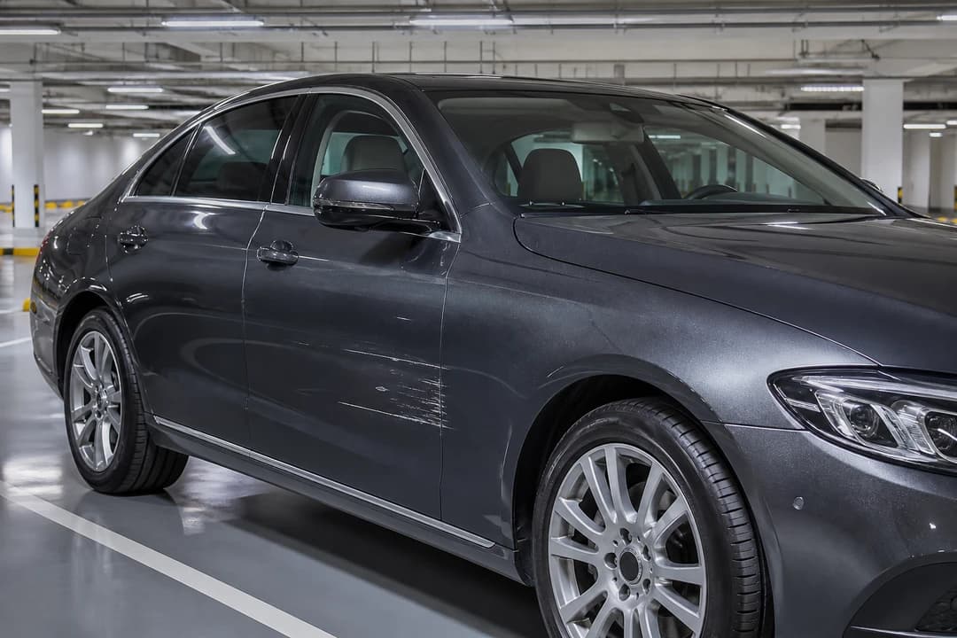 Minor door scrape on a luxury rental sedan in Dubai mall parking for police report rental car damage Dubai decisions