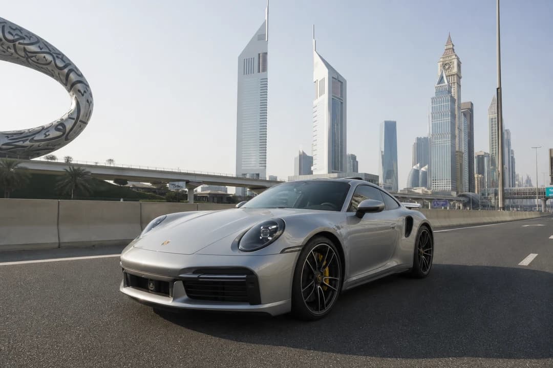 Porsche 911 Turbo S on Sheikh Zayed Road at morning for luxury car comparison Dubai everyday pace