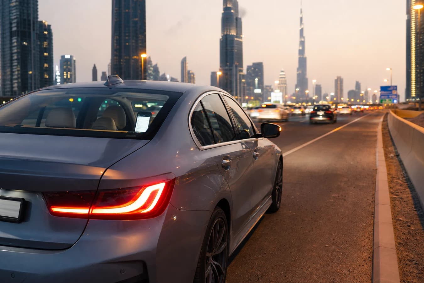 Rental car breakdown Dubai: luxury hire car safely stopped on hard shoulder with hazard lights at dusk