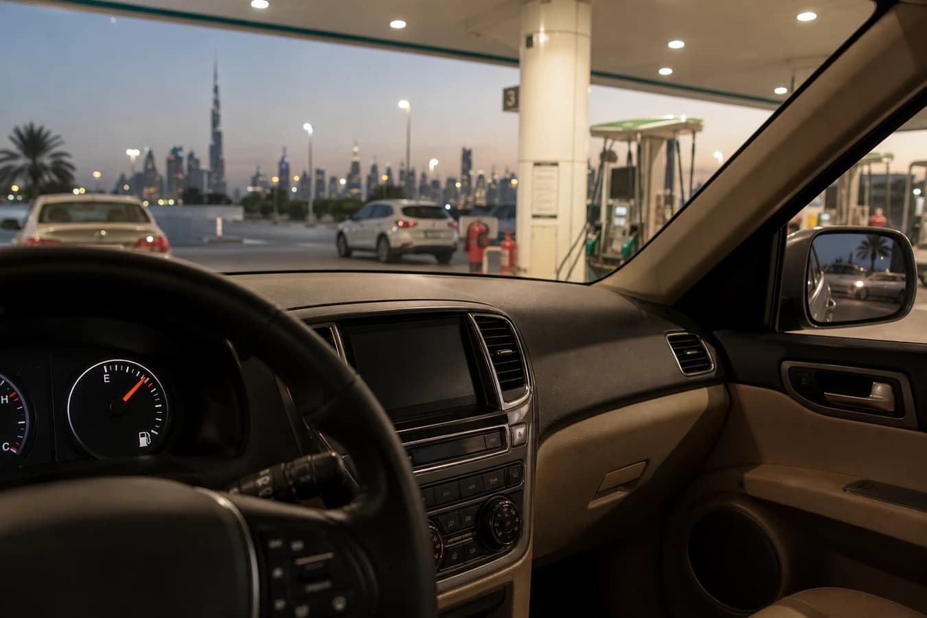 Rental car fuel policy Dubai: luxury SUV fuel gauge near full at a Dubai petrol station before return