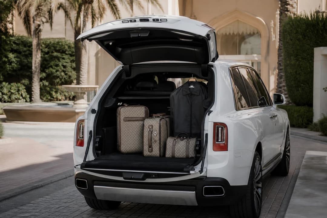 Cullinan open hatch with soft luggage at a Dubai villa for luxury car rental Dubai packing