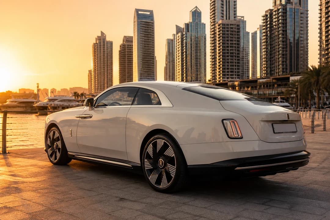 Rolls-Royce Spectre on Dubai Marina waterfront at golden hour for exotic car rental Dubai guests who actually want quiet
