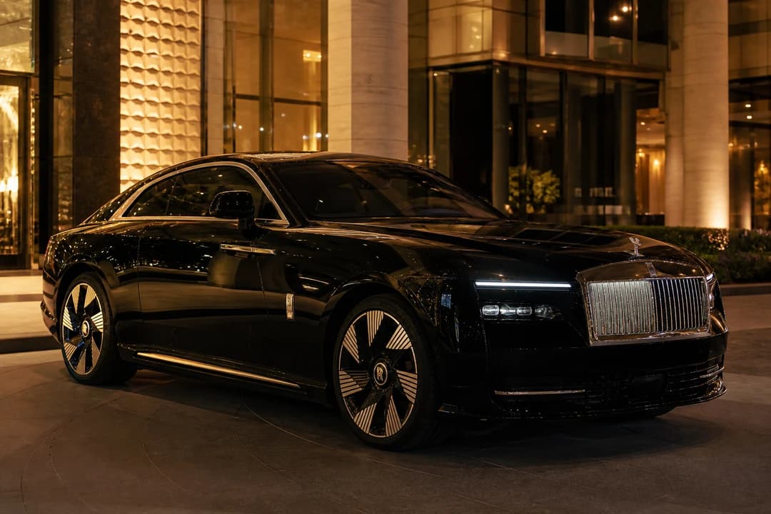 Rolls-Royce Spectre at a Downtown Dubai hotel porte-cochère at night for best luxury car Dubai silent arrivals