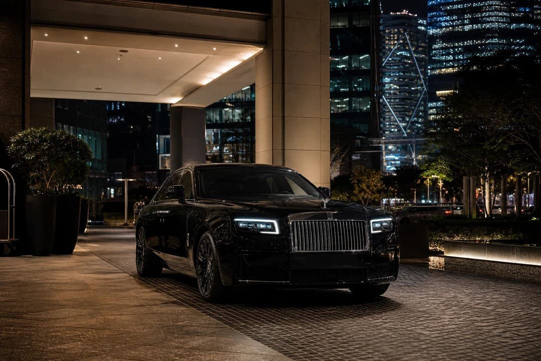 Rolls-Royce Ghost at a DIFC podium after evening Sheikh Zayed Road luxury car rental transfer