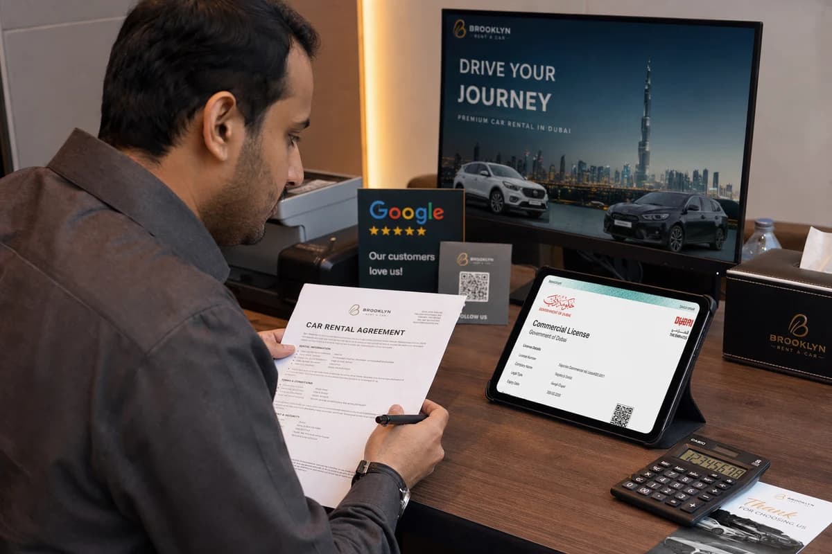 Guest reviewing rental contract and trade licence details before Dubai car hire payment
