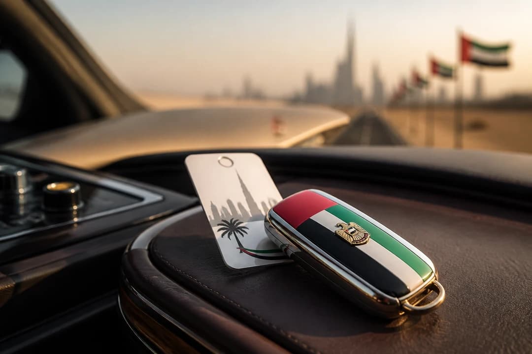 Luxury car key fob and valet ticket on a console before a UAE National Day road trip handover