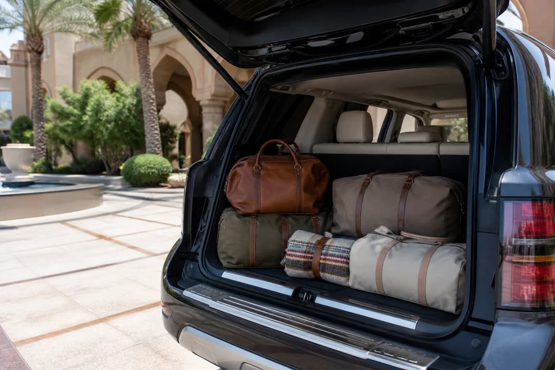 Open luxury SUV boot packed for a UAE National Day long weekend road trip from a Dubai hotel kerb