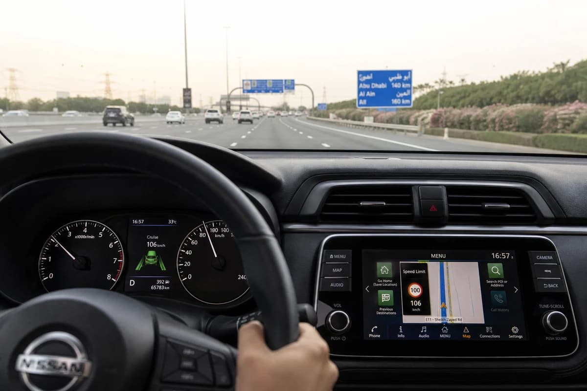 Rental driver checking posted speed limit and navigation overlay in Dubai