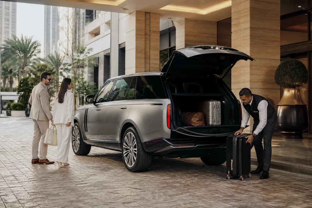 Luxury car comparison Dubai: silver SUV at a hotel porte-cochère for a seven-day weekly hire
