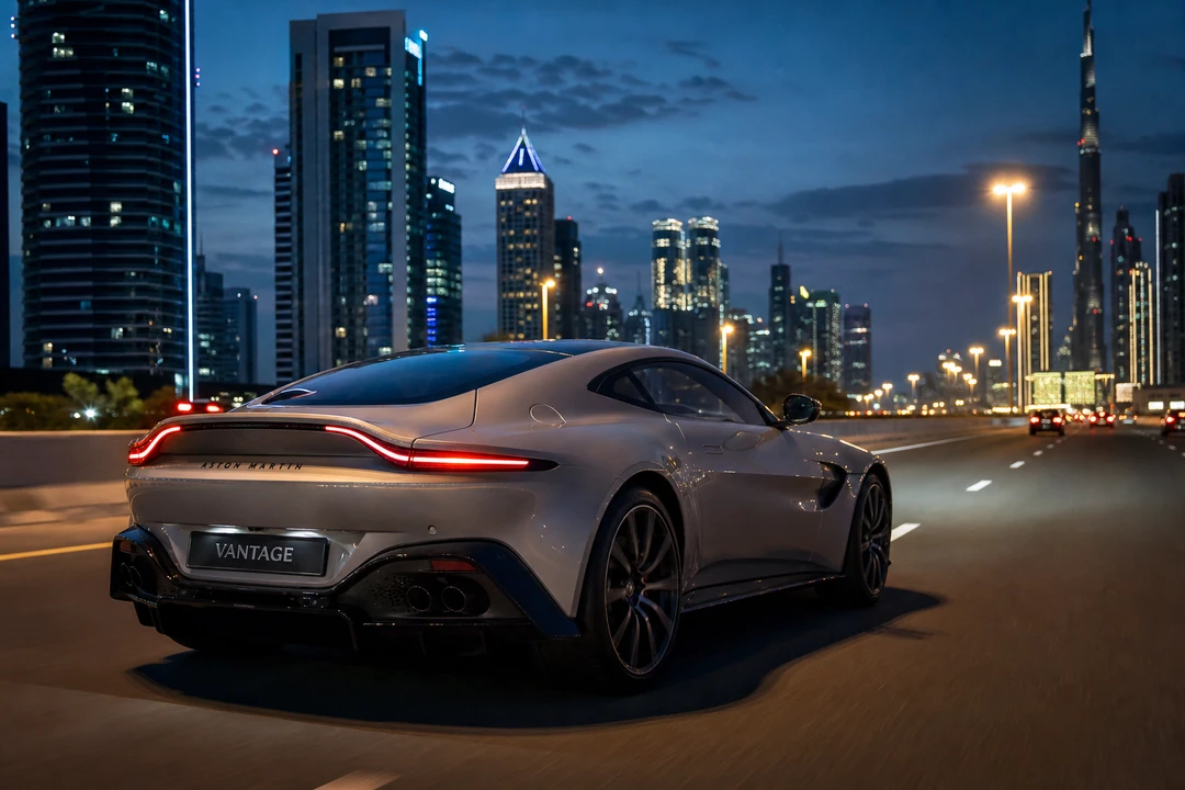 Rent Aston Martin Dubai: silver Vantage sports coupe on Sheikh Zayed Road at blue hour