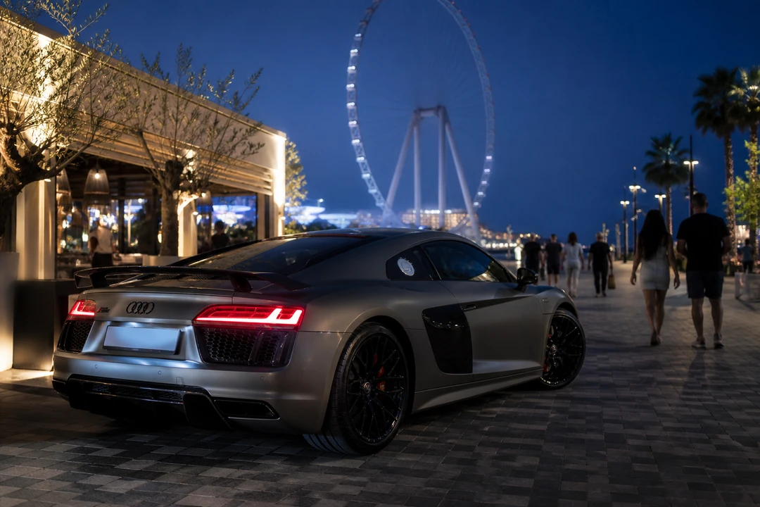 Audi R8 at Bluewaters Island at blue hour for exotic car rental Dubai evening arrivals