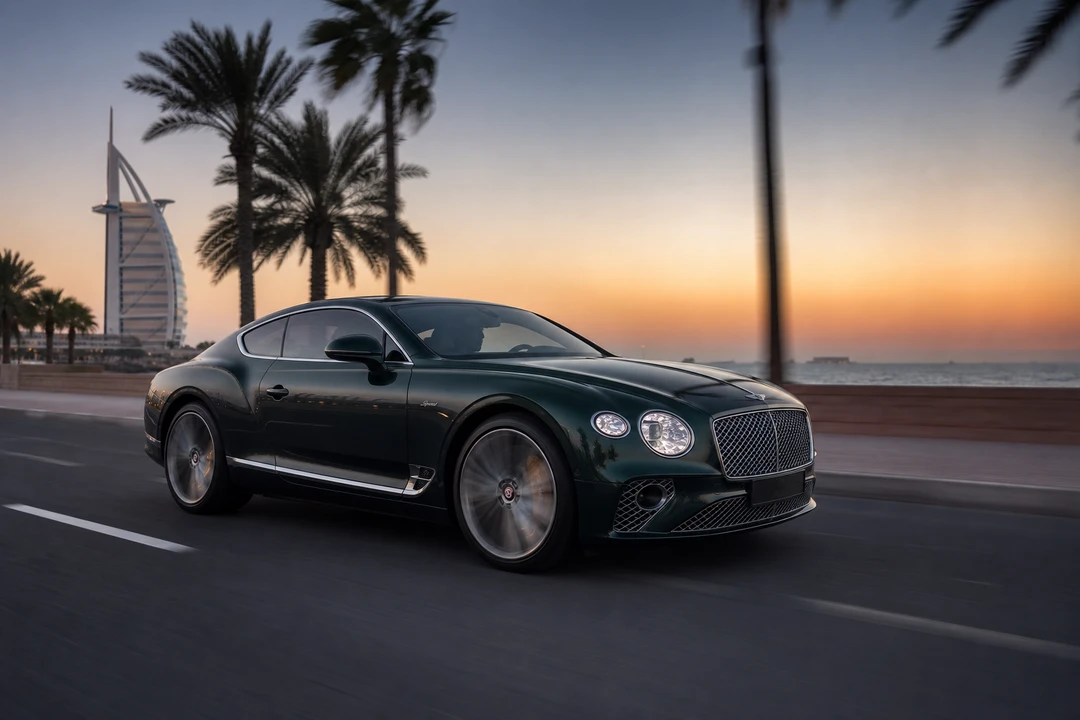 Rent Bentley Dubai: British racing green Continental GT Speed on Jumeirah Beach Road at dusk