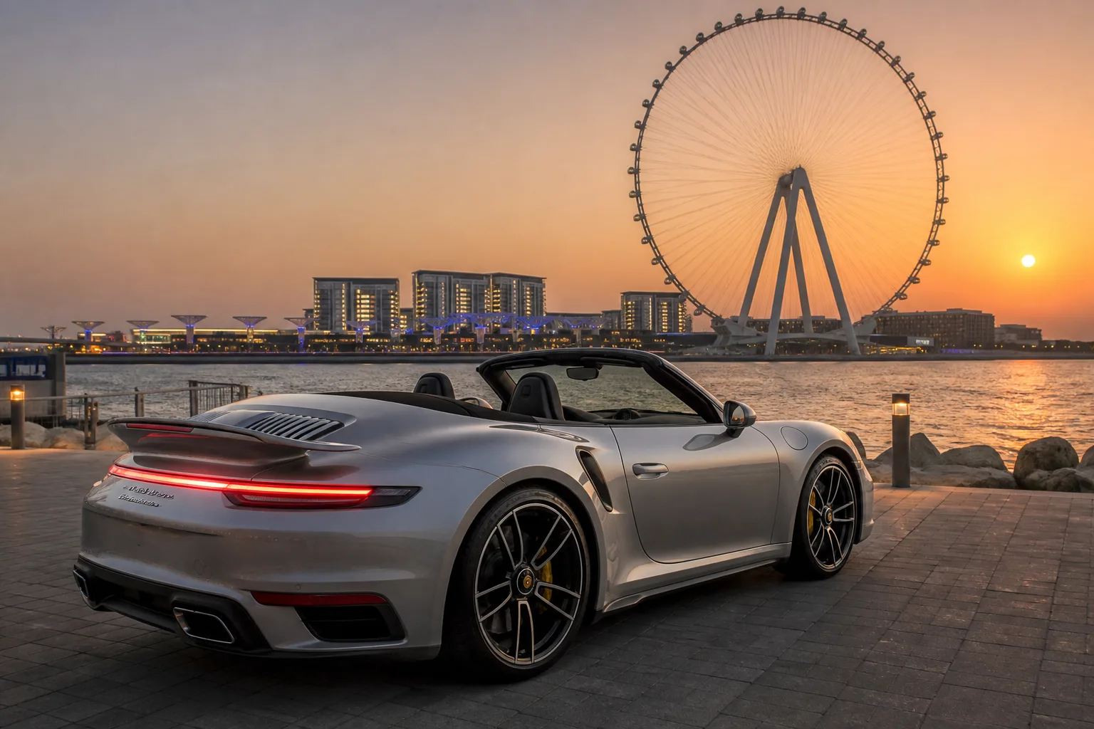 Car rental Bluewaters Island Dubai hero with a Porsche 911 Cabriolet on the waterfront at dusk