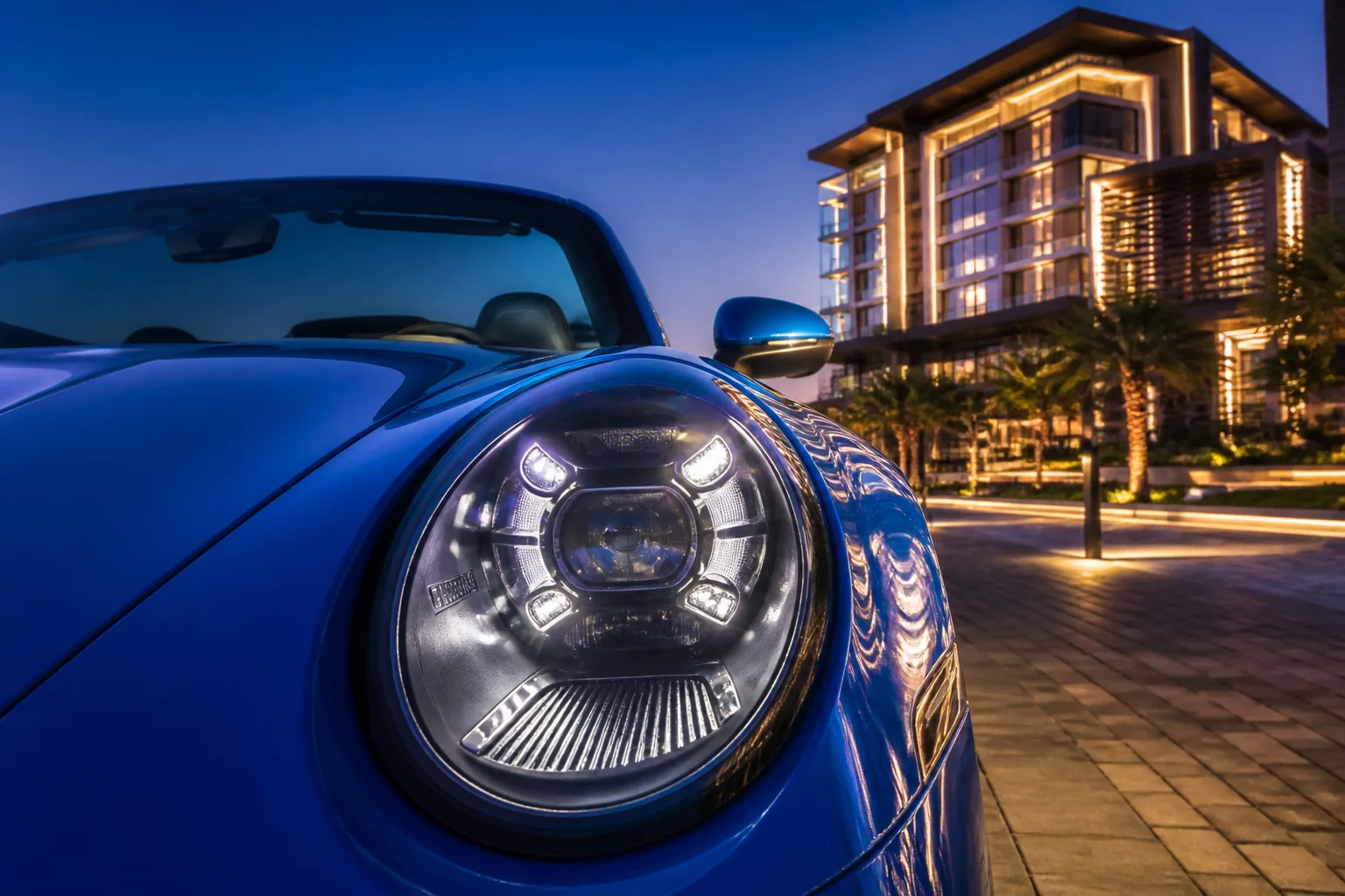 Porsche 911 Turbo S Cabriolet headlight against Bluewaters Island architecture
