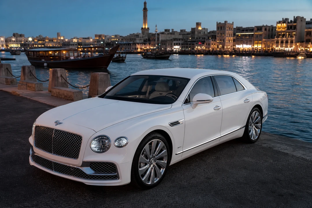 Bentley Continental GT on Dubai Creek in Deira at blue hour with wooden dhows for UAE road trip rental evenings