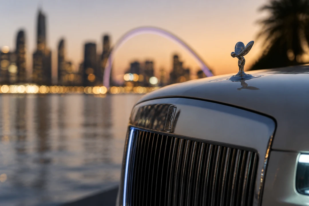 Rolls-Royce Cullinan grille and Spirit of Ecstasy detail against Dubai Creek Harbour waterfront lights