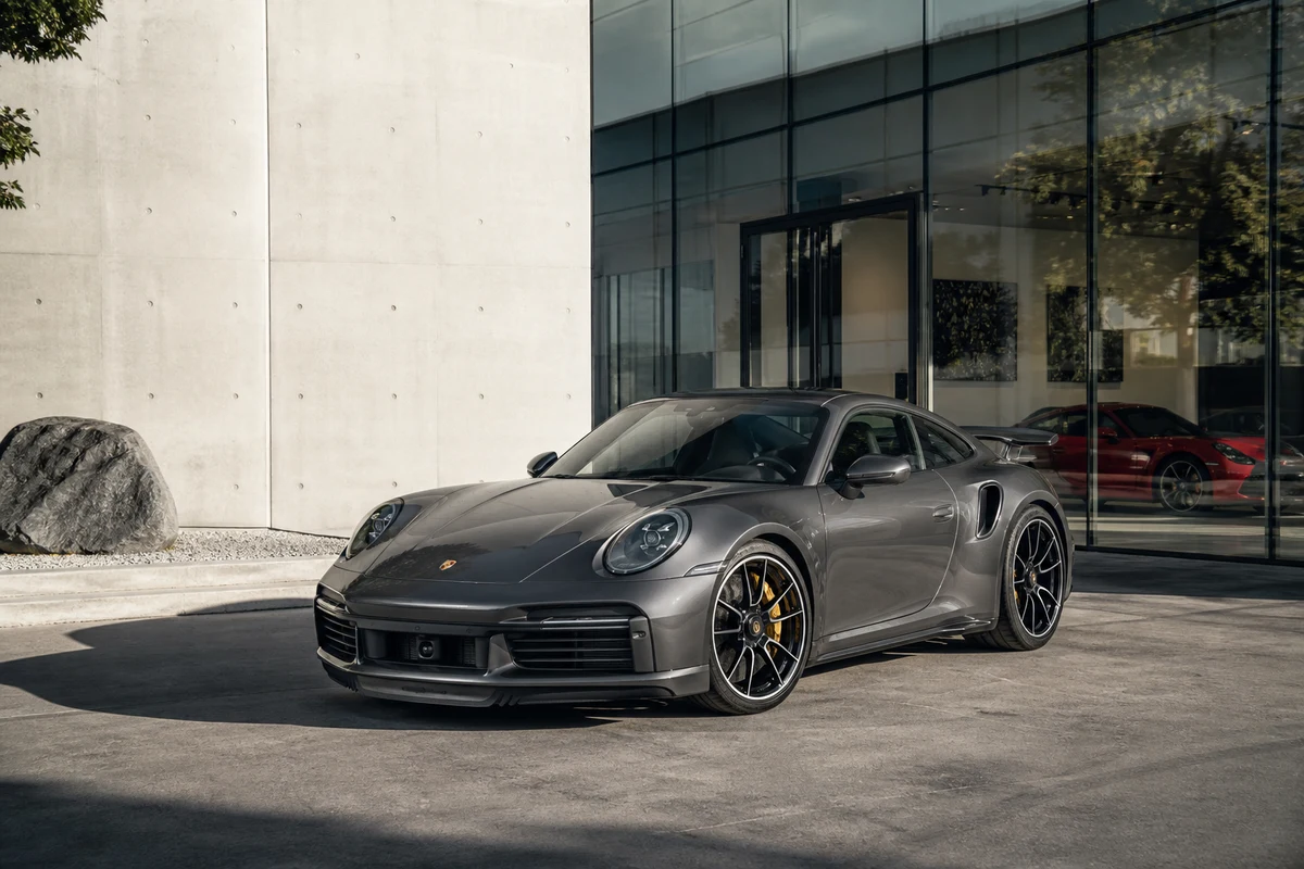 Porsche 911 Turbo S at a Dubai Design District showroom for best cars to rent Dubai creative evenings