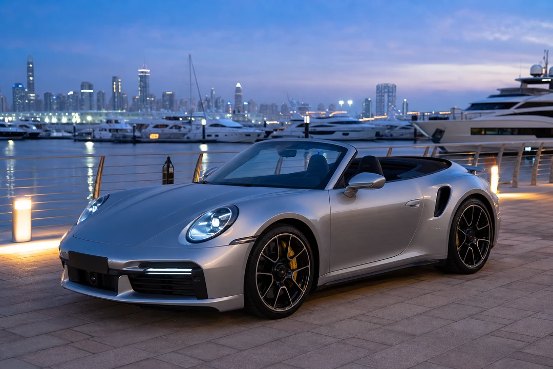 Porsche 911 Turbo S Cabriolet beside yacht docks near Dubai Harbour for Marina arrivals at blue hour