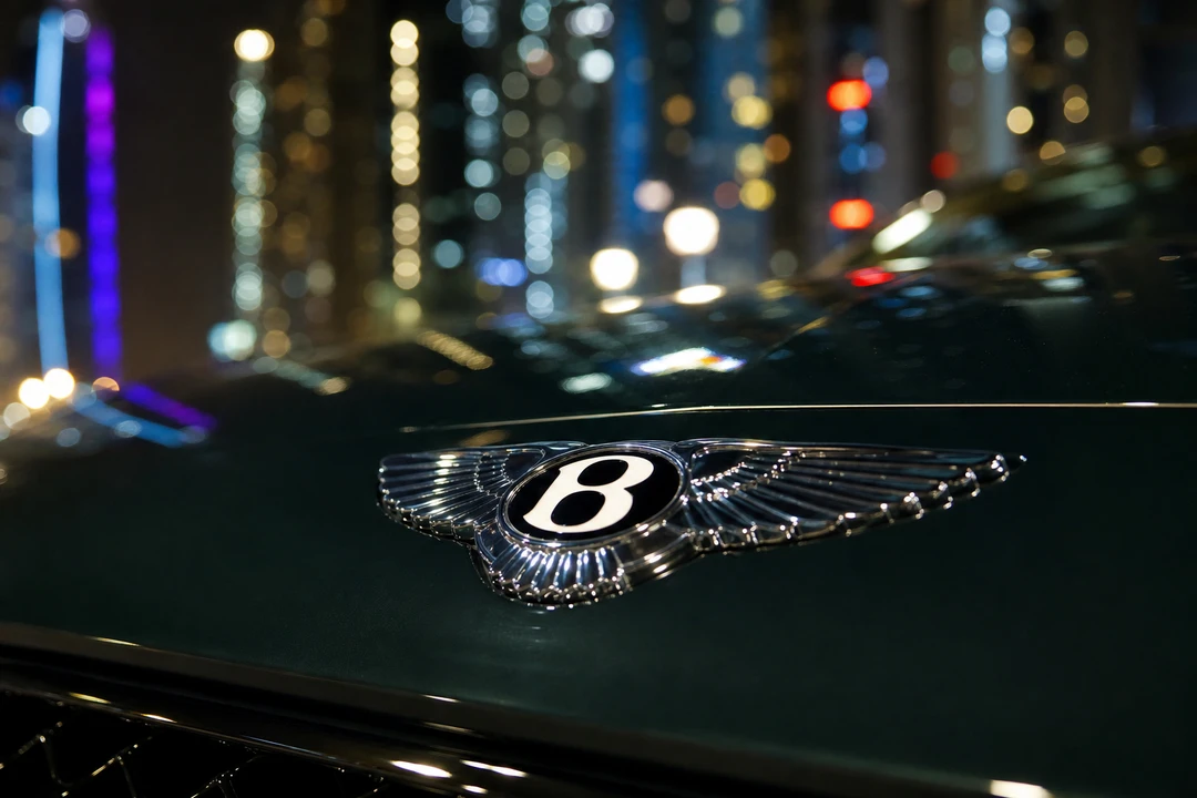 Bentley emblem detail with Dubai Marina tower lights for luxury rental decisions