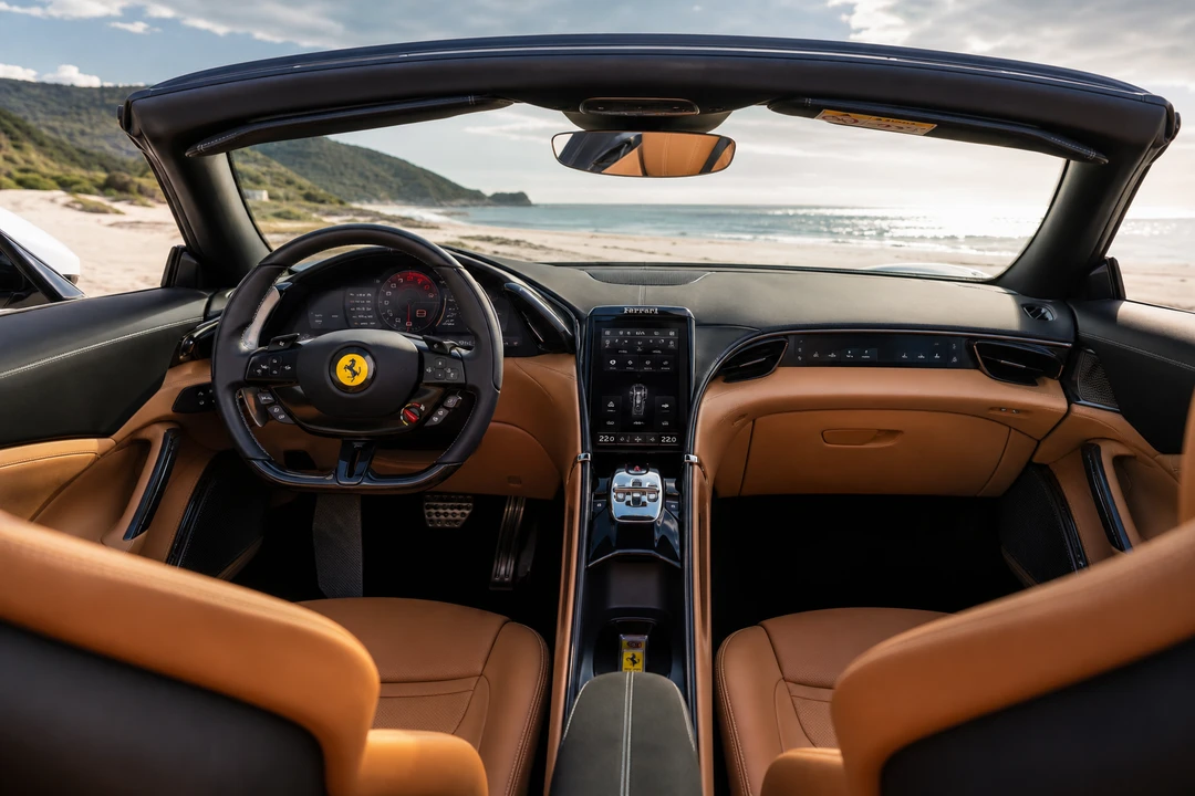 Ferrari Roma Spyder interior with roof down for convertible rental JBR beach afternoons