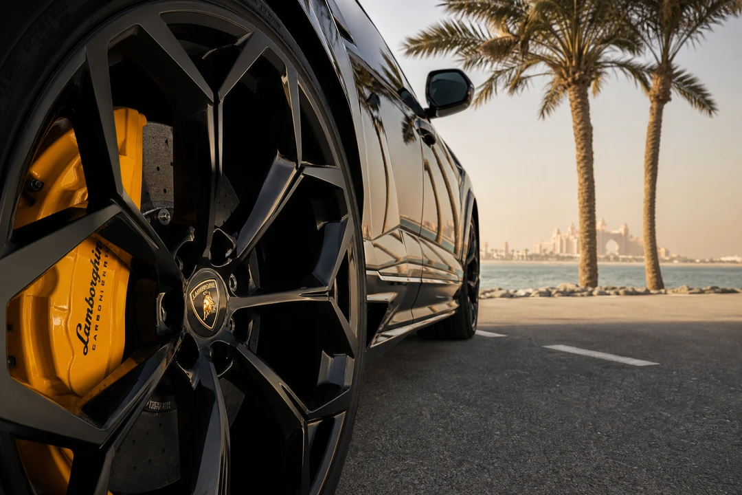 Lamborghini Urus wheel detail with Palm Jumeirah palm trees for island rental decisions