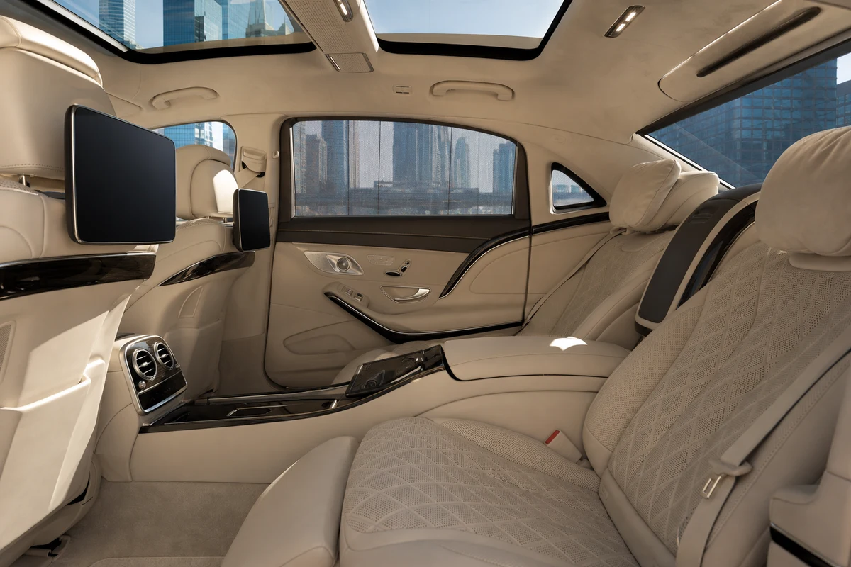 Maybach rear cabin for DIFC client meetings with finance-district towers through the windows