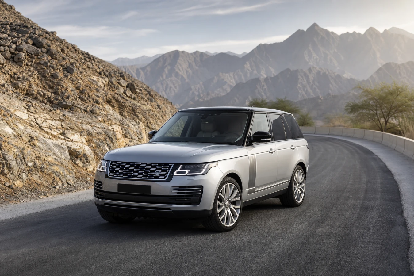 Best luxury cars Dubai winter road trip hero with a Range Rover on a Hatta mountain road at morning