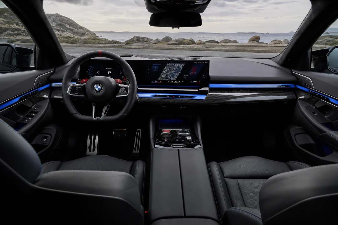 BMW M5 M Sport cockpit and curved display for executive performance sedan driving in Dubai