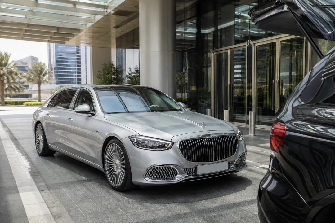 Office car handover Dubai with luxury sedan at a Business Bay tower podium in daylight