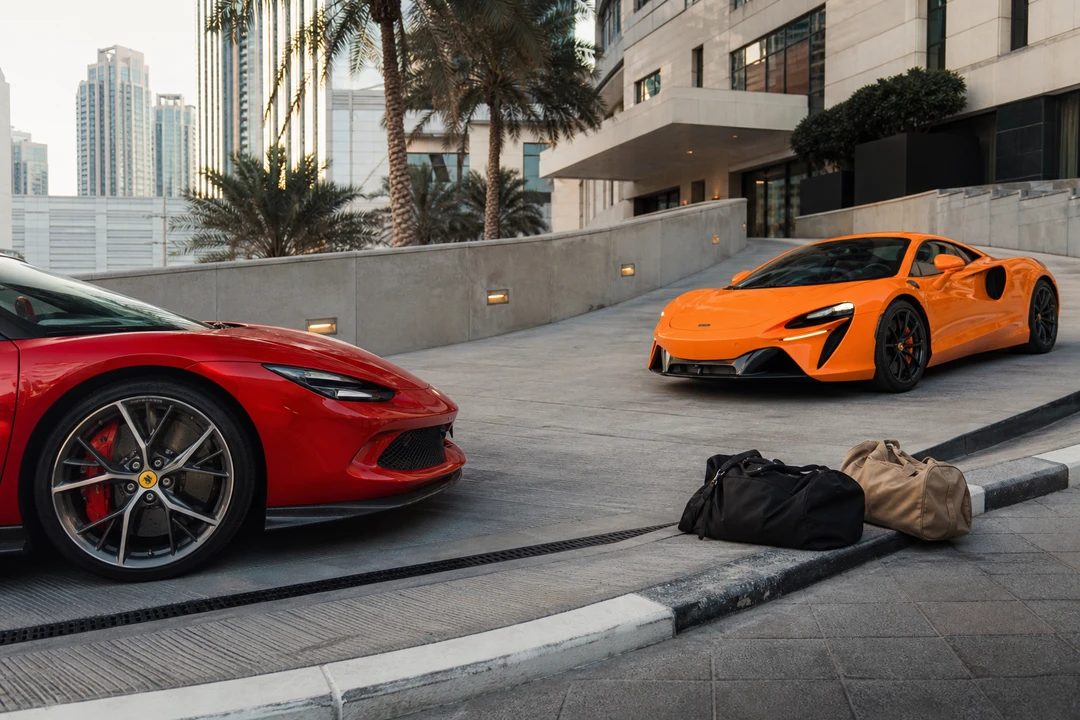 Ferrari 296 GTB and McLaren Artura at a steep d3 ramp for luxury car hire Dubai nose clearance and soft bags