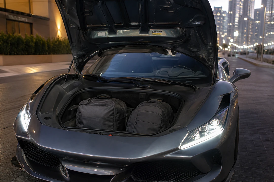 Ferrari F8 Tributo Spider front luggage space with soft cabin bags for a two-seat Dubai weekend