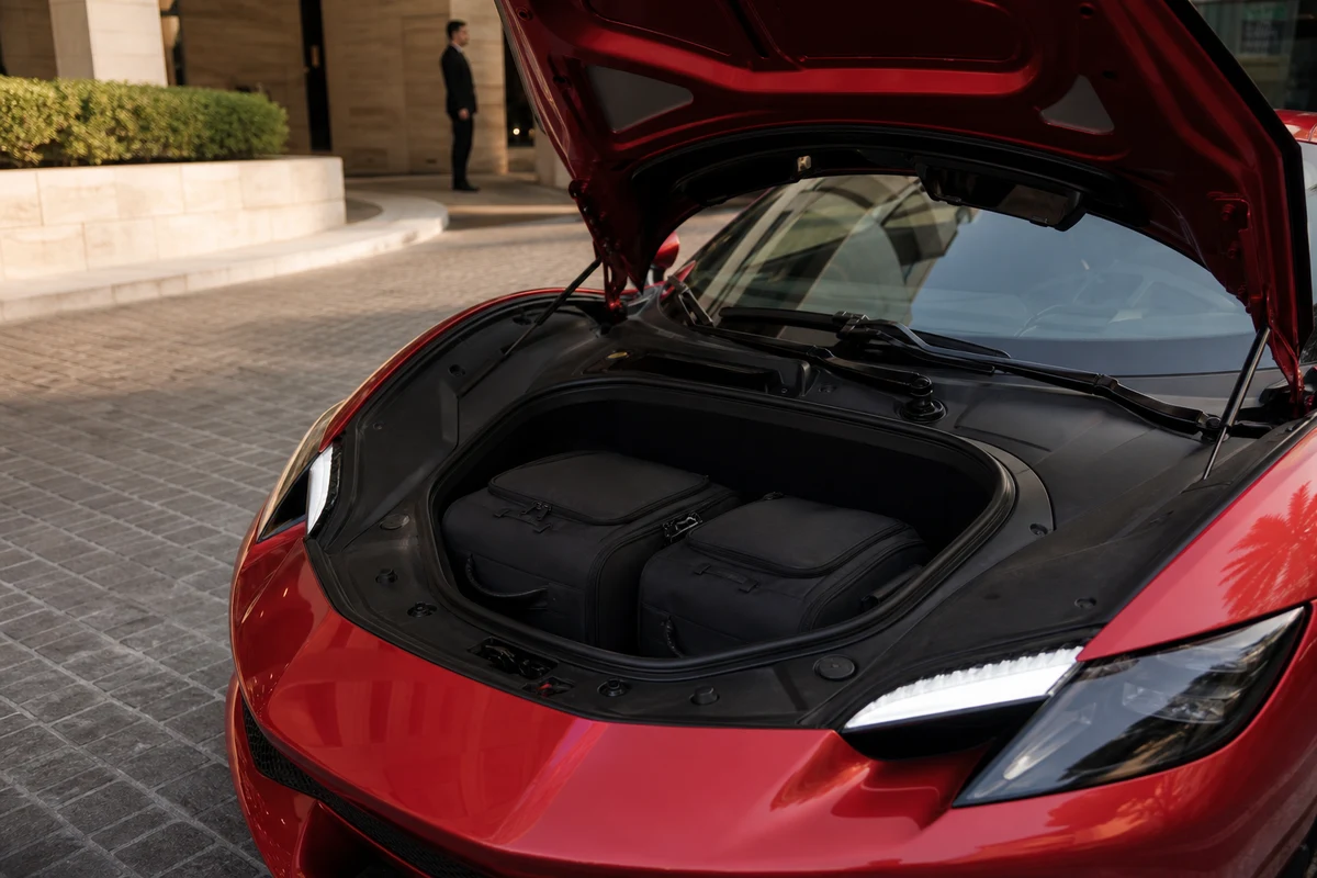 Ferrari 296 GTB front luggage with two soft bags for luxury car hire Dubai two-seat packing