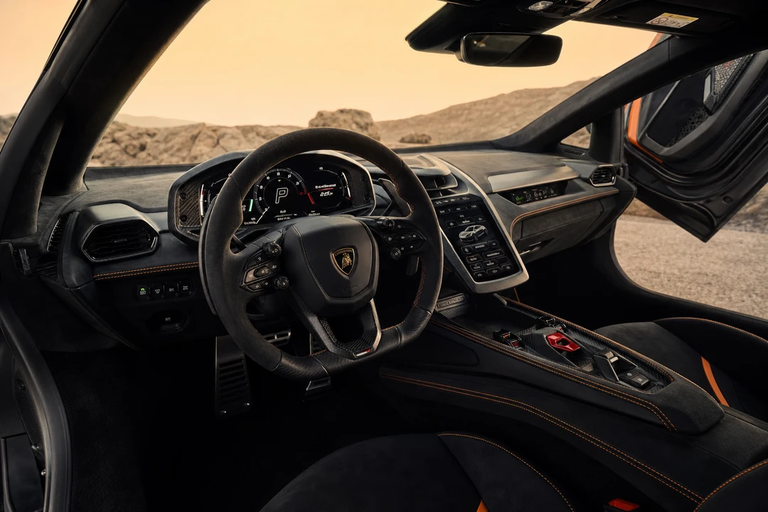 Lamborghini Revuelto interior cockpit with hexagonal steering wheel and raised scissor doors for high-impact drives