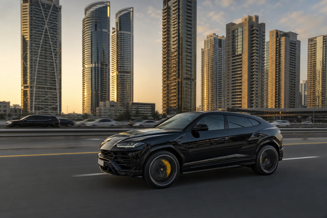 Lamborghini Urus on Sheikh Zayed Road with Marina towers for luxury SUV rental Dubai commutes