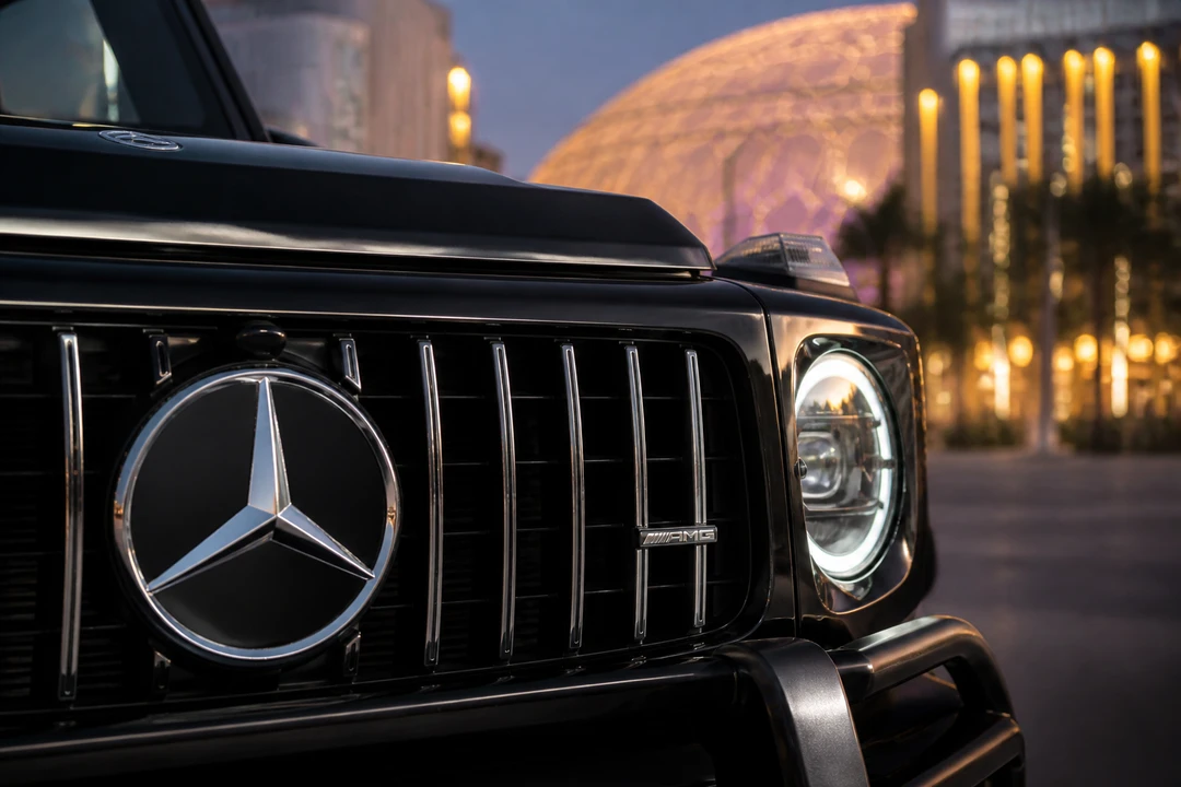 G63 grille detail at dusk with Expo City lights for luxury car rental Dubai South identity