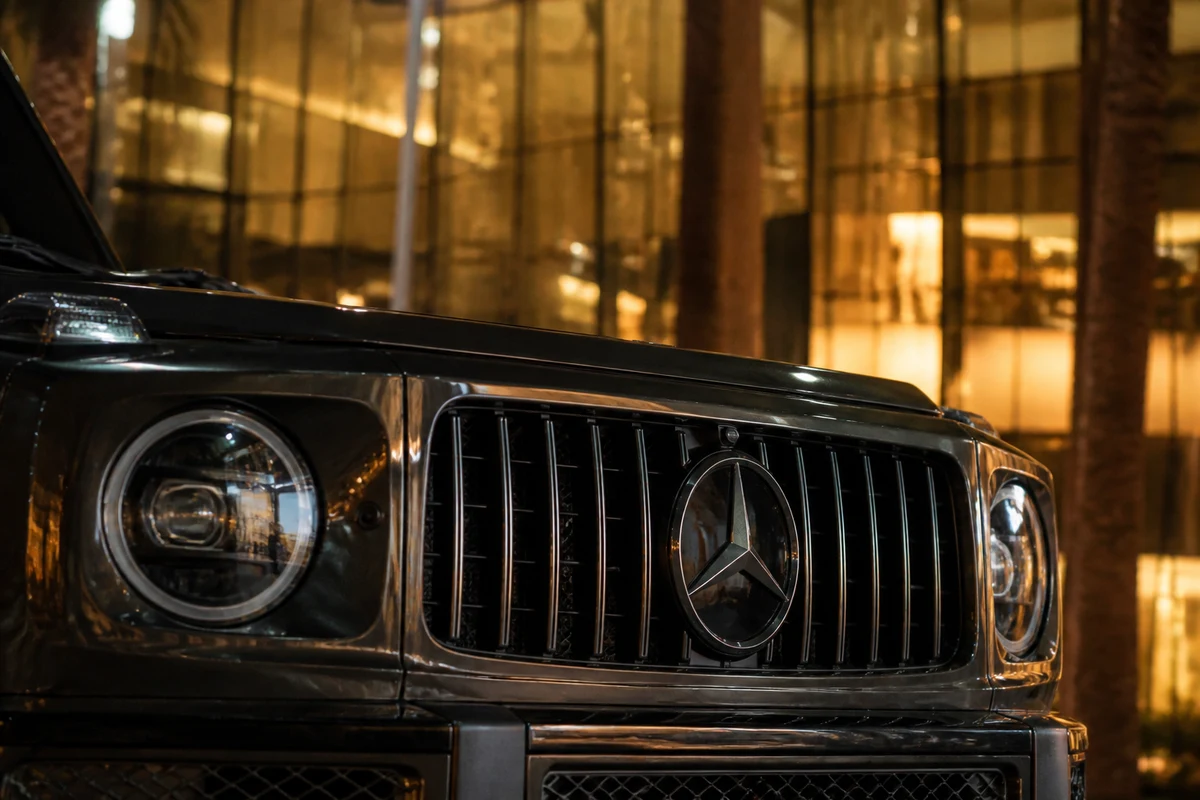 Mercedes-Benz G-Class grille reflecting Mall of the Emirates glass at night