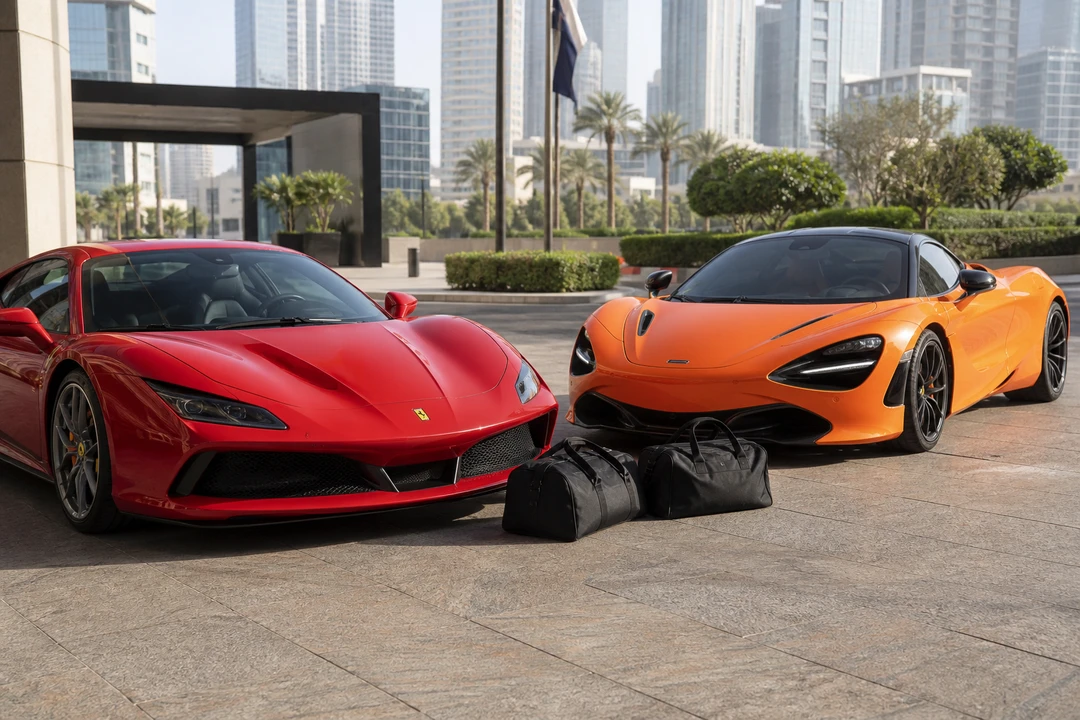 Ferrari F8 Tributo and McLaren 720S at a DIFC kerb with two soft duffels for luxury car hire Dubai packing