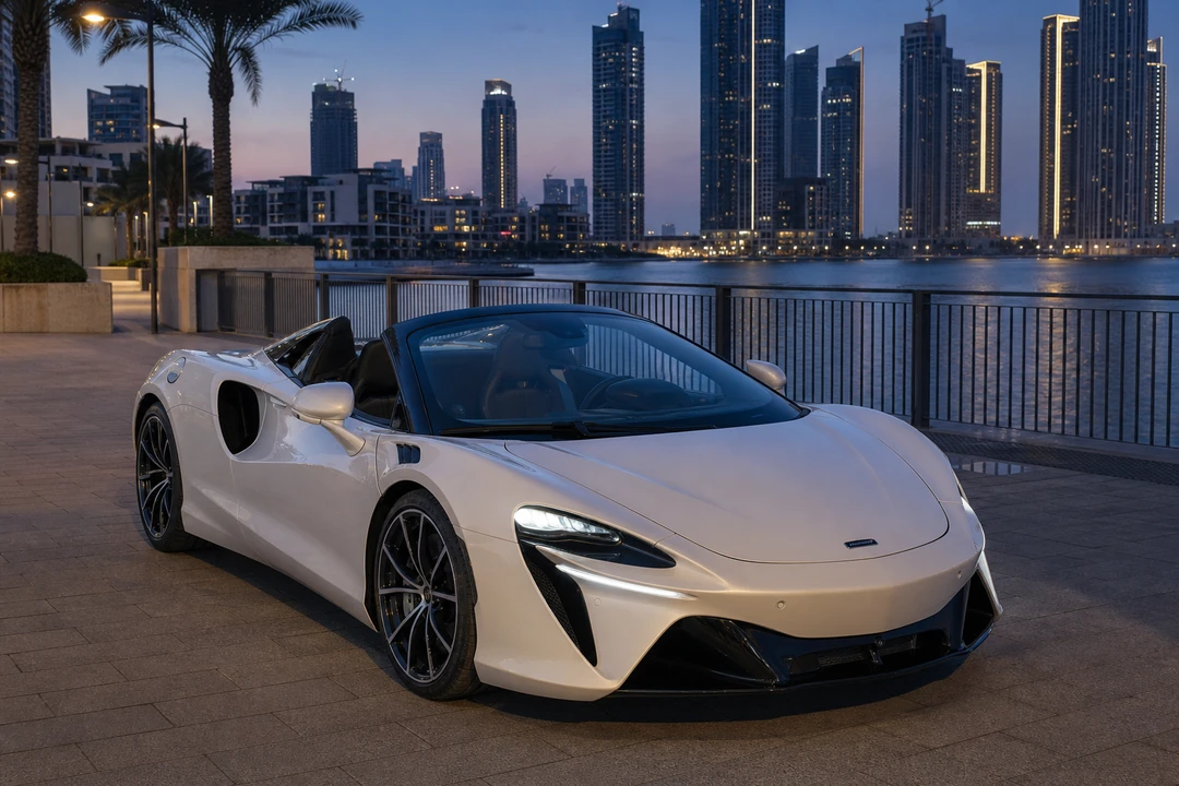 McLaren Artura Spider roof-down at a Dubai waterfront harbour at dusk for exotic car rental Dubai first evening