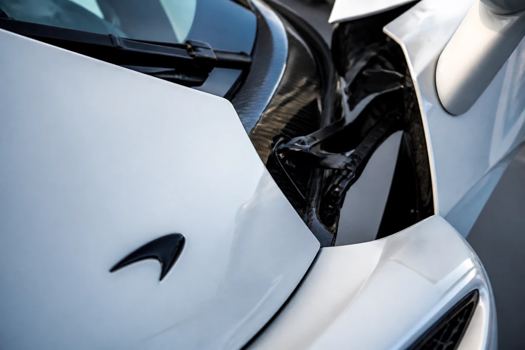 McLaren Speedmark badge and dihedral door hinge on a white Artura for McLaren rental Dubai guide identity