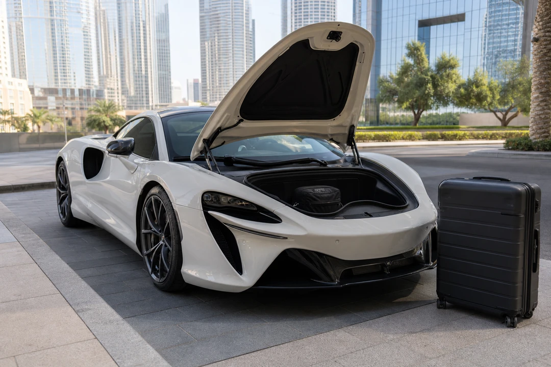 Silica white Artura frunk with one soft cabin bag and a rejected hard case at a Downtown hotel for luxury car rental Dubai packing